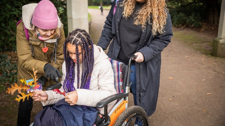 Family exploring the Halloween trail in the park at Anglesey Abbey, Gardens and Lode Mill, Cambridgeshire